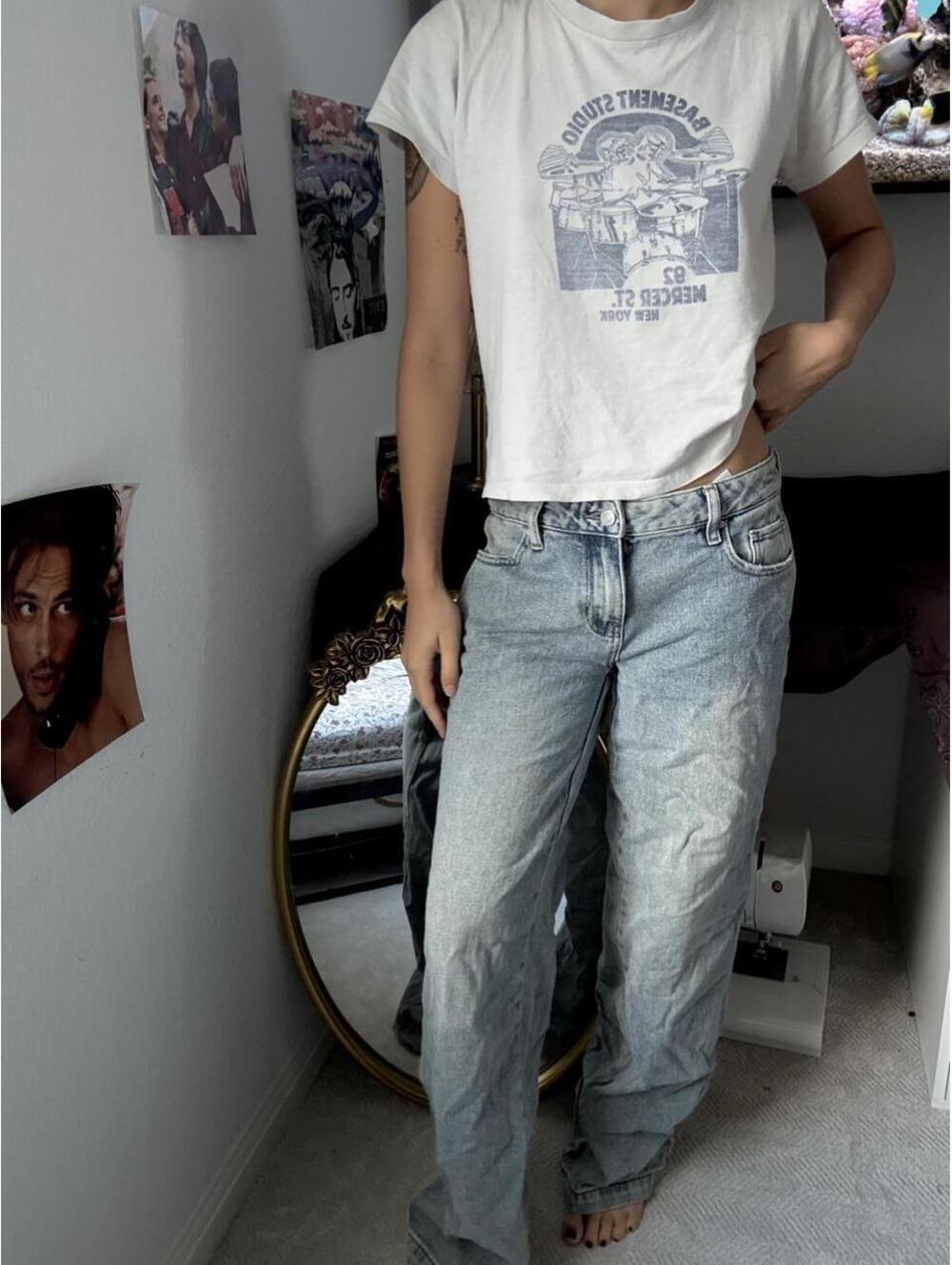 Low rise baggy blue jeans with graphic of a building with text